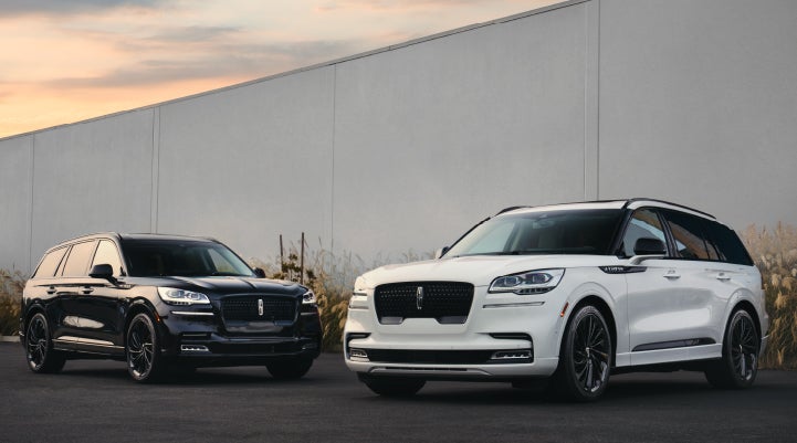 Two Lincoln Aviator® SUVs are shown with the available Jet Appearance Package | Brinson Lincoln of Corsicana in Corsicana TX
