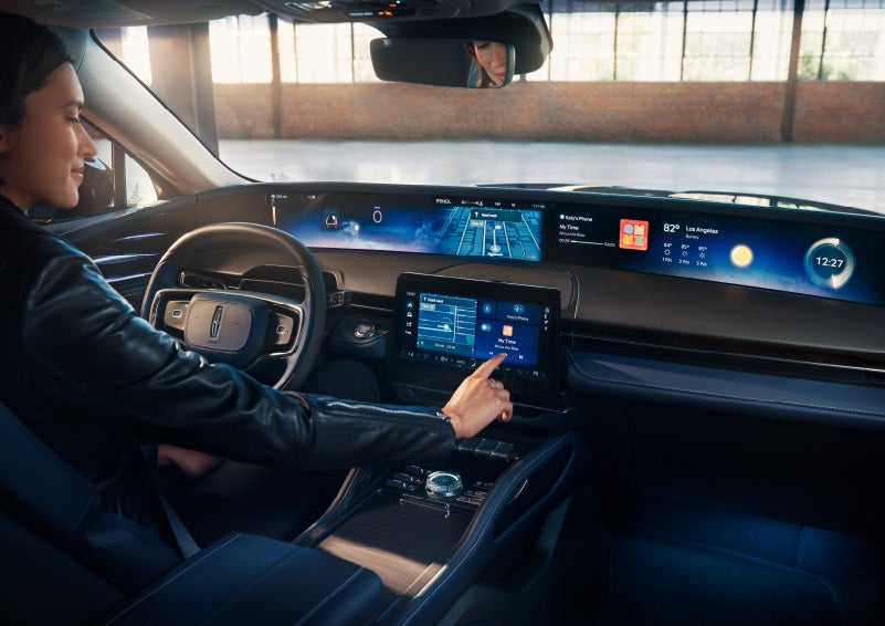 The driver of a 2024 Lincoln Nautilus® SUV interacts with the center touchscreen. | Brinson Lincoln of Corsicana in Corsicana TX